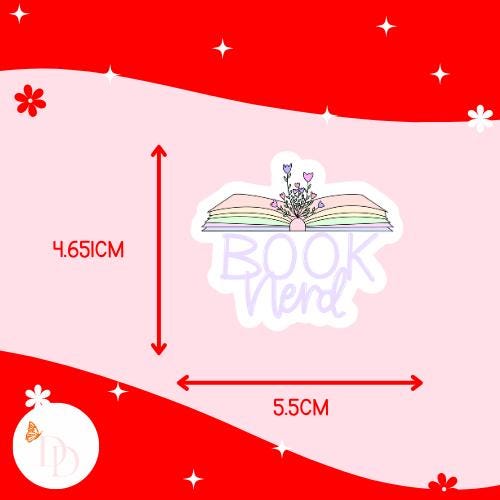 Sticker of an open book with flowers and text saying "book nerd" on a pink and red background with measurements. The sticker is 4.651cm high and 5.5cm wide.
